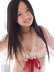 Mayumi Yamanaka Asian smiles while undressing with erotic moves