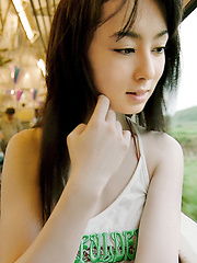 Rina Akiyama Asian with sexy lips rubs her cunt of bar outdoor